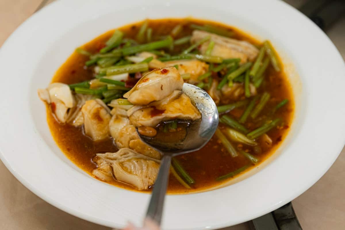 Chunky white fish pieces in thick spicy red sauce with vegetables
