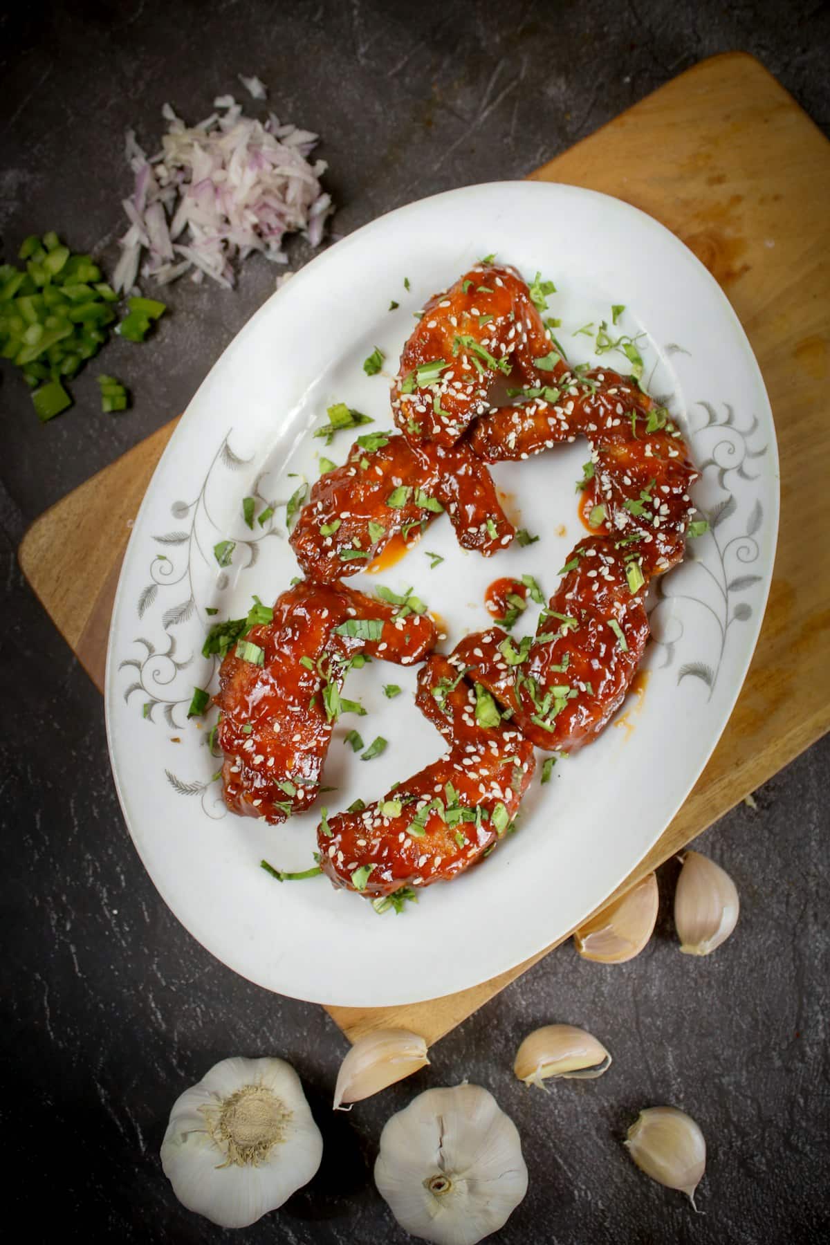 Glossy glazed fried chicken pieces topped with sesame seeds