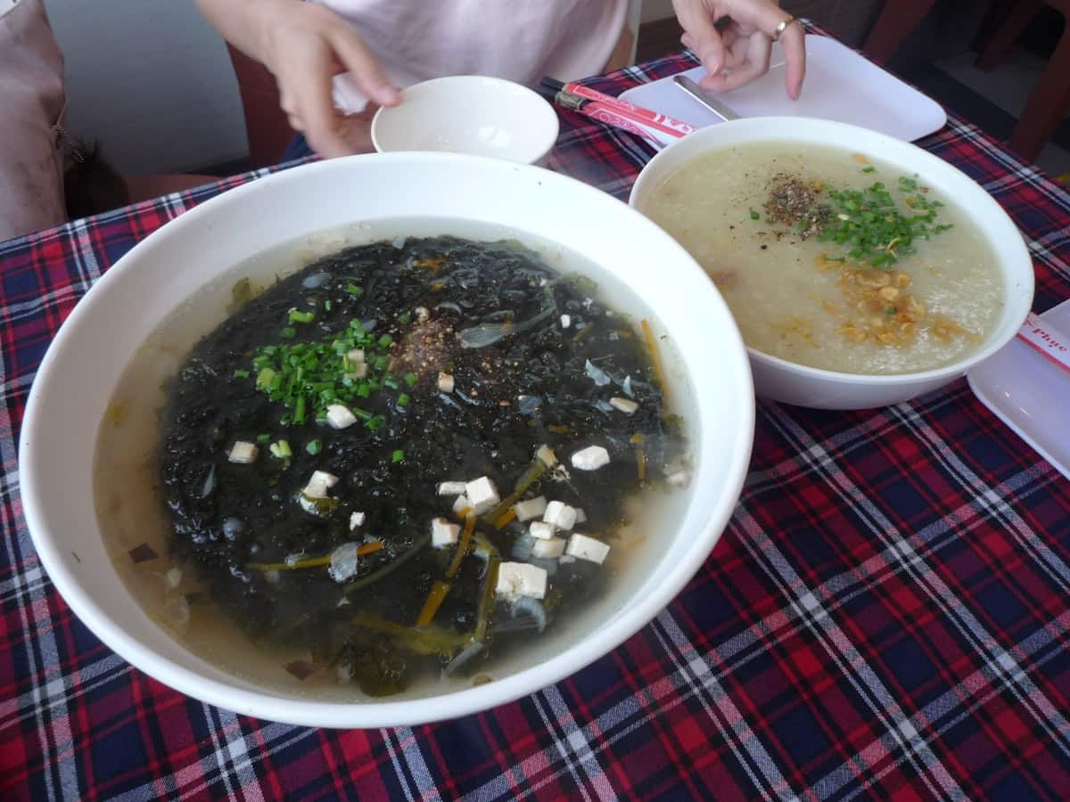 Dark seaweed soup with tofu and green onion in a bowl