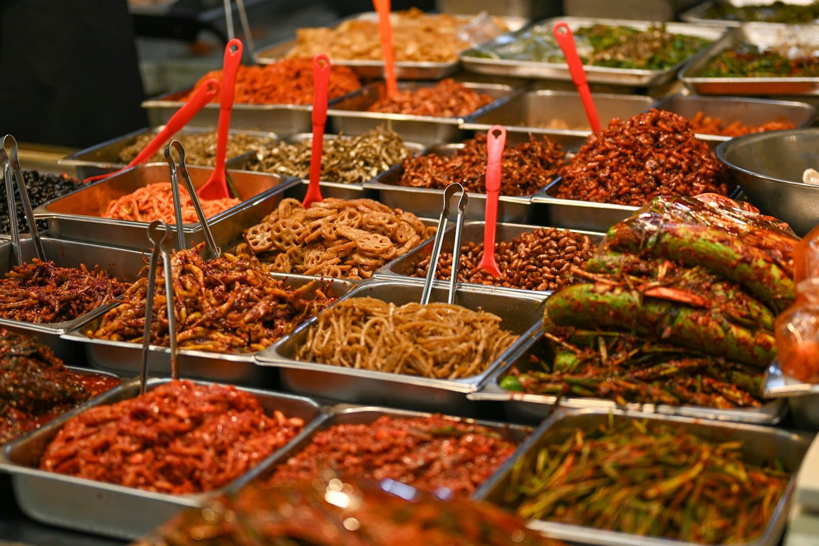 Assorted Korean side dishes displayed in metal trays