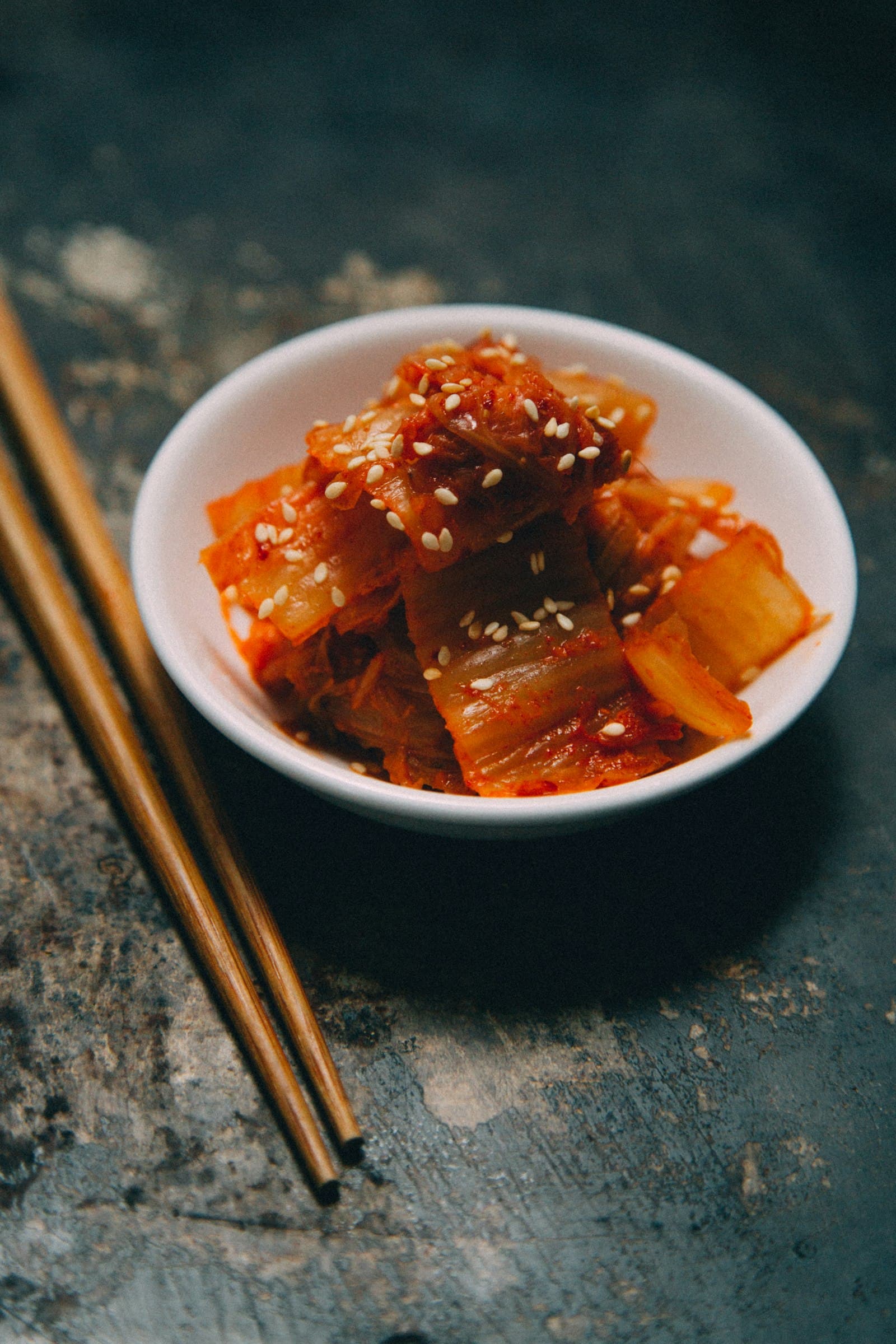 A small bowl of freshly cut kimchi topped with sesame seeds