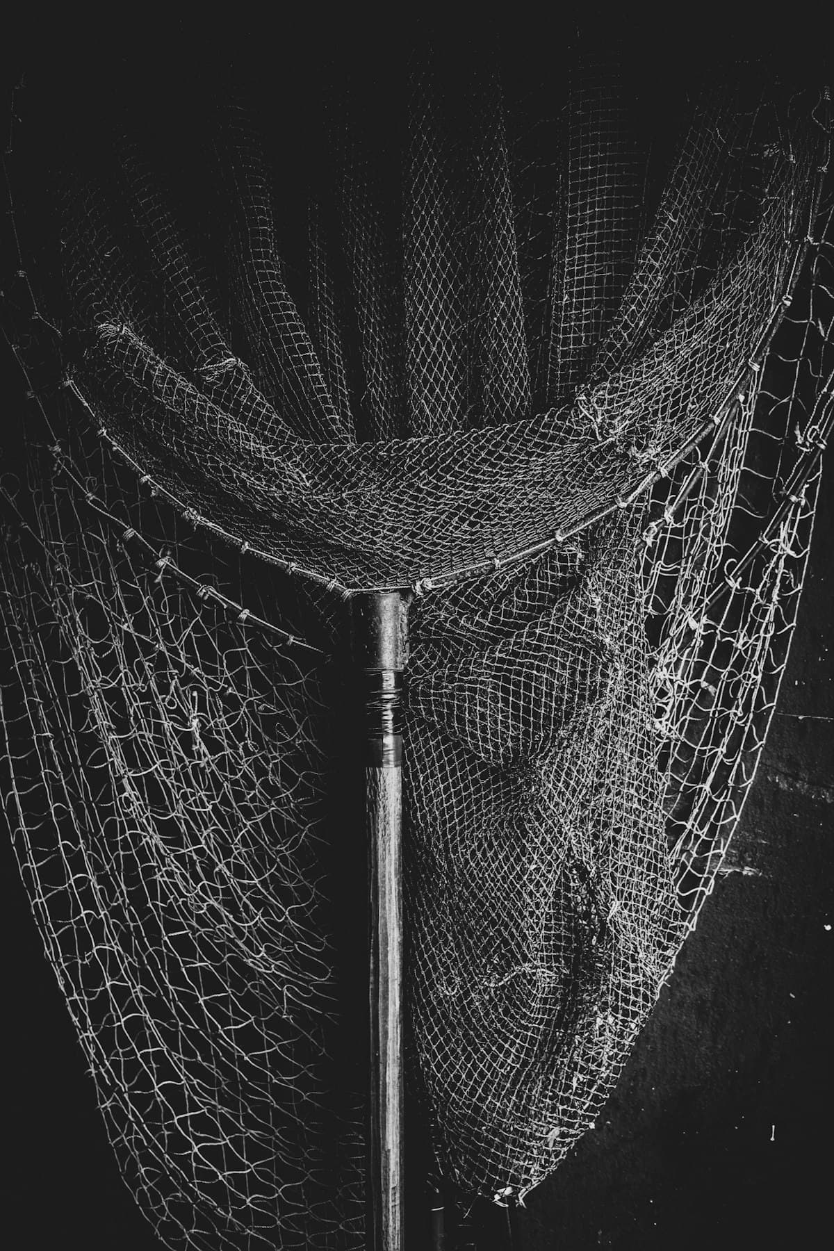 A black and white close-up of a fishing net