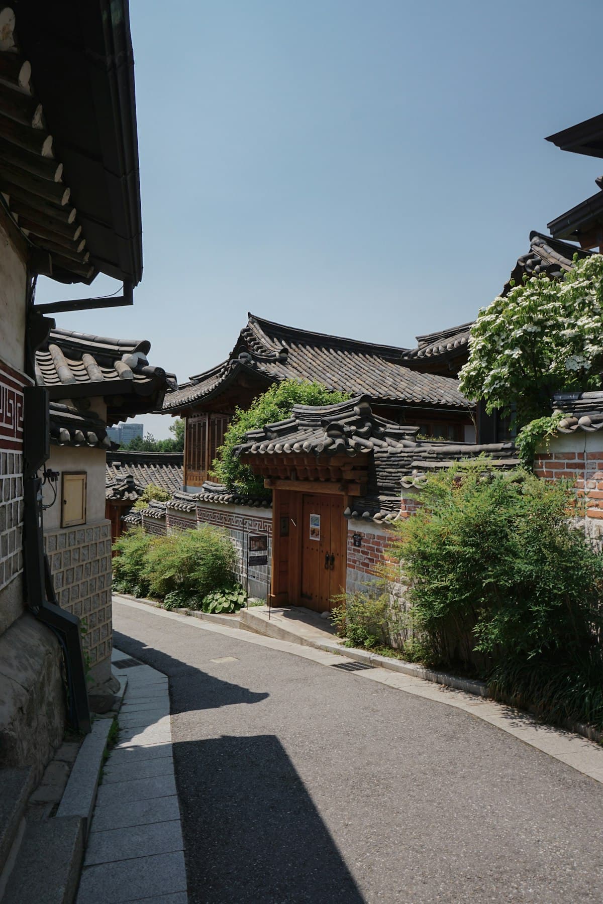 A quiet street of traditional hanok houses in a Korean village