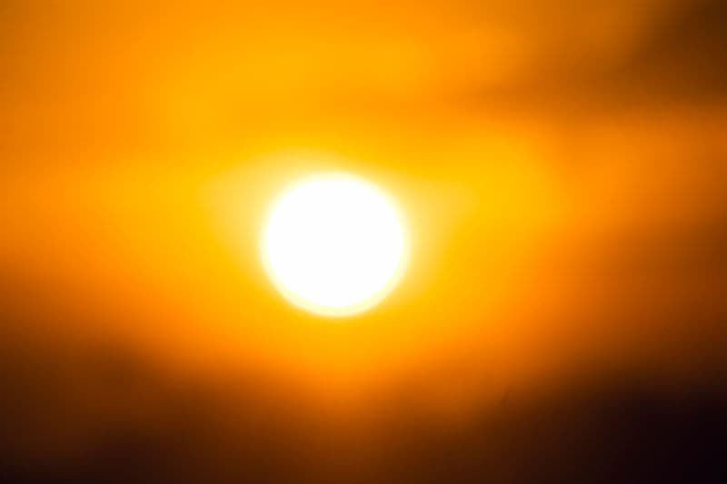A blazing bright sun against an orange sky
