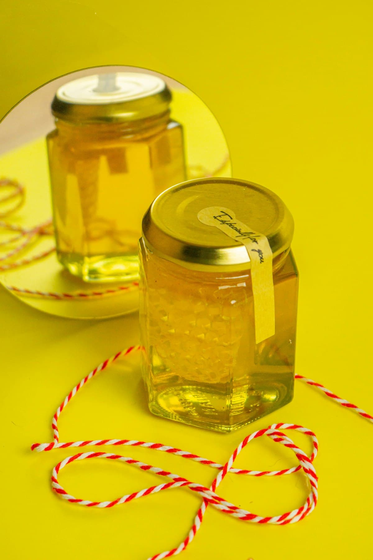 A jar of honey with a handwritten gift tag