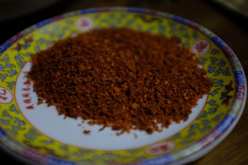 A pile of coarse red Korean chili flakes on a plate