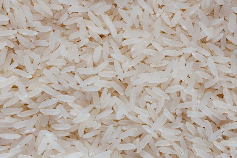 A close-up pile of uncooked white rice grains