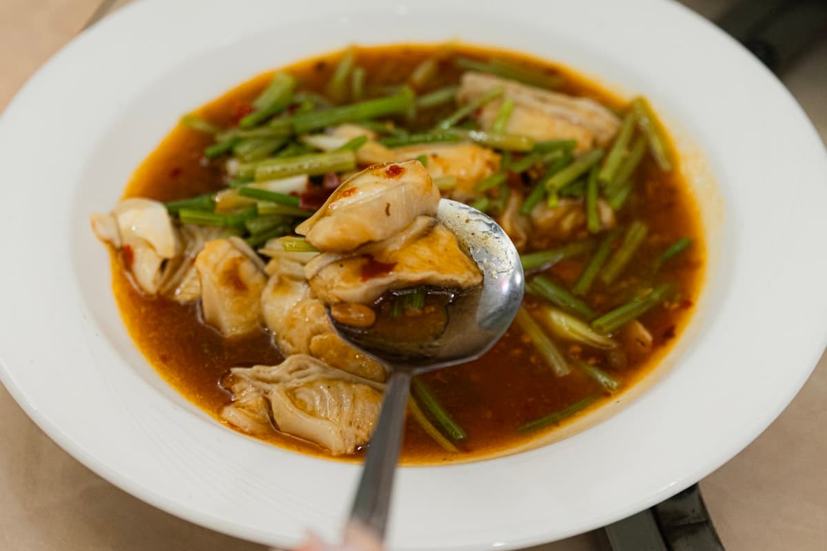 Chunky white fish pieces in thick spicy red sauce with vegetables