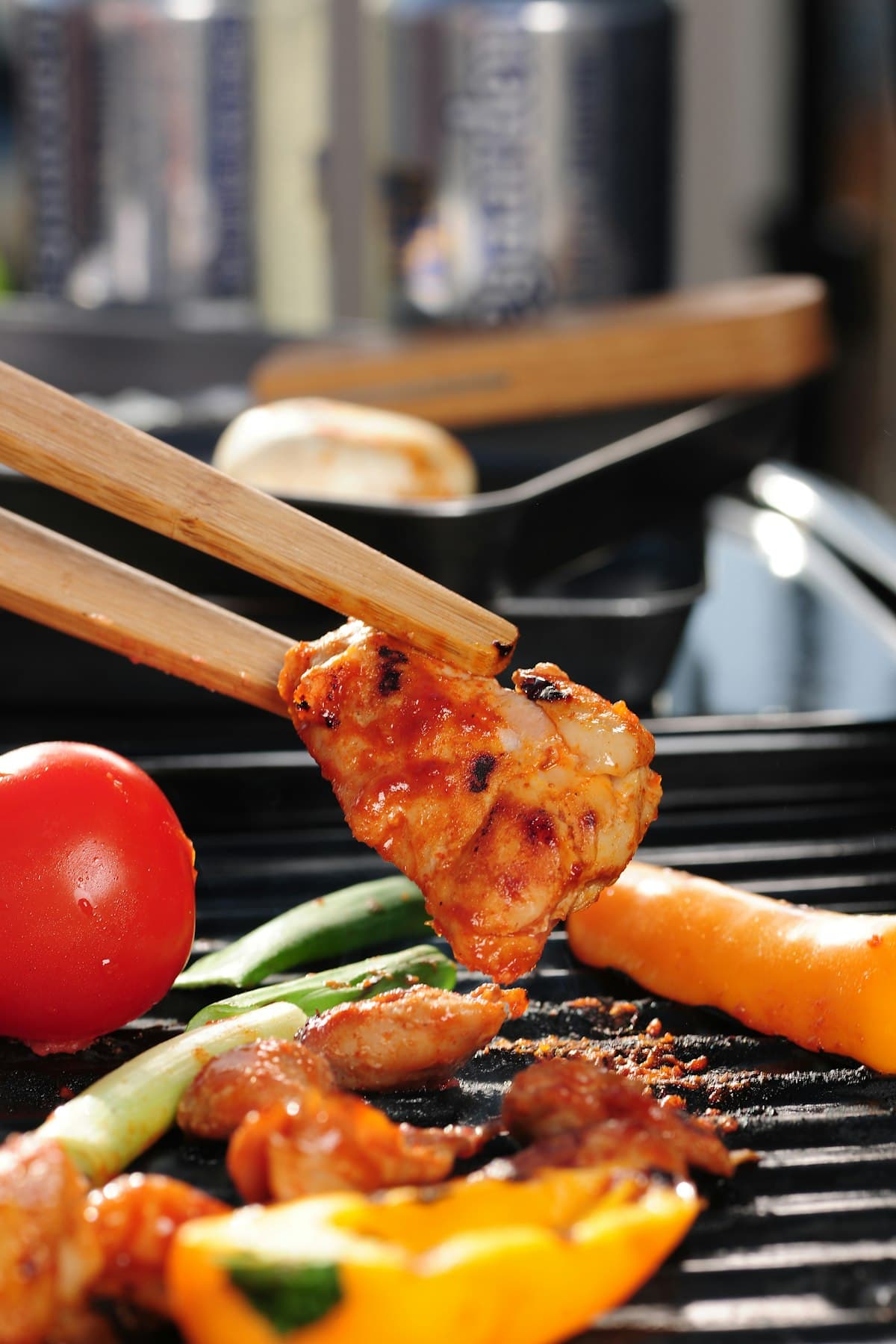 Sliced marinated chicken thigh grilled with onion, glossy with sauce