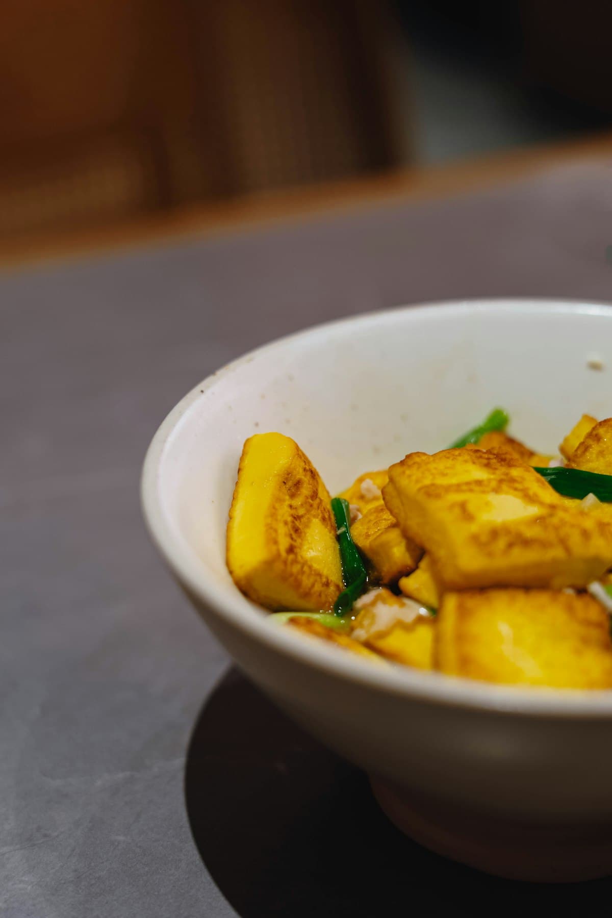 Golden pan-seared tofu cubes glazed in a savory sauce