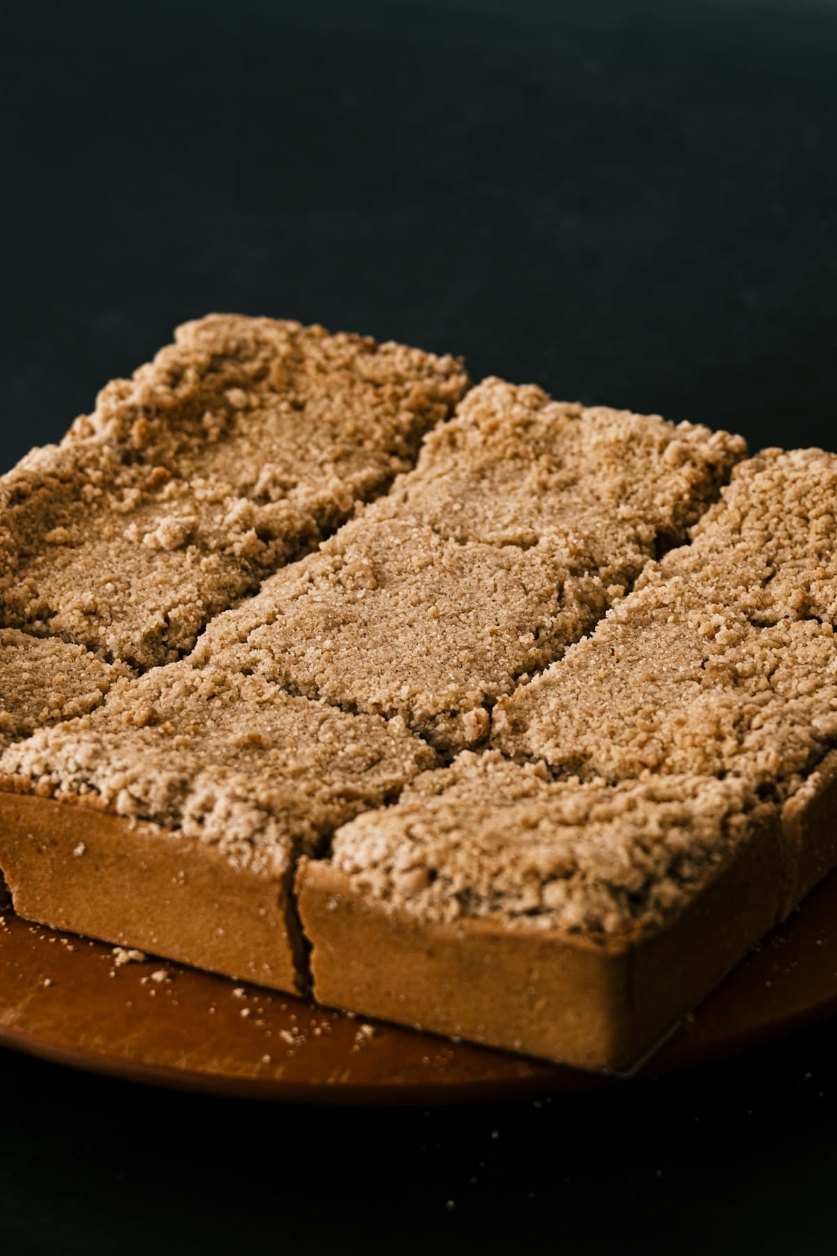 A block of rice cake coated in roasted soybean powder, sliced into pieces