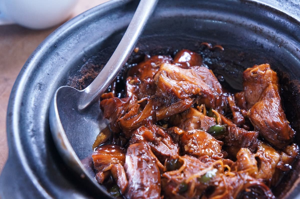 Dark soy-braised beef chunks glossy in sauce in a pot