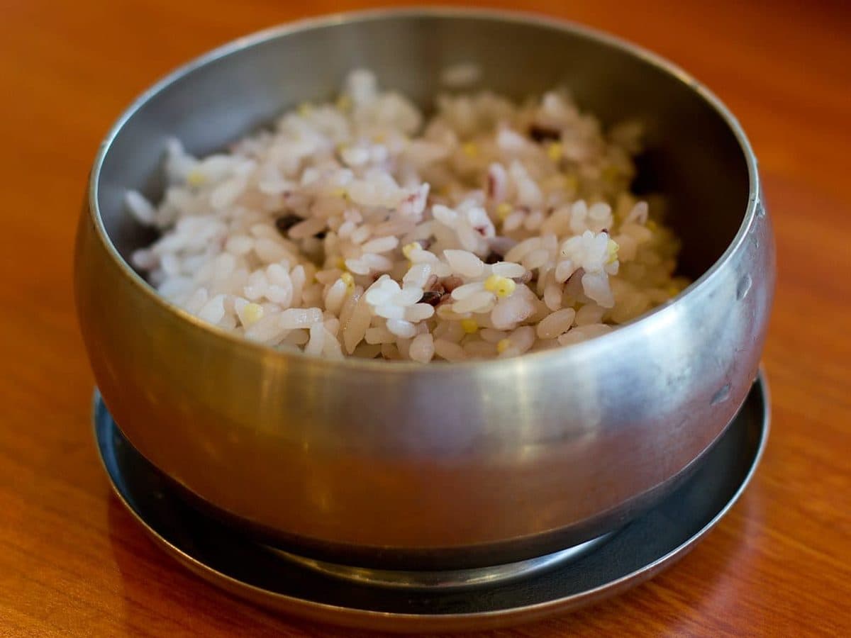 Cooked multigrain rice in a brass bowl