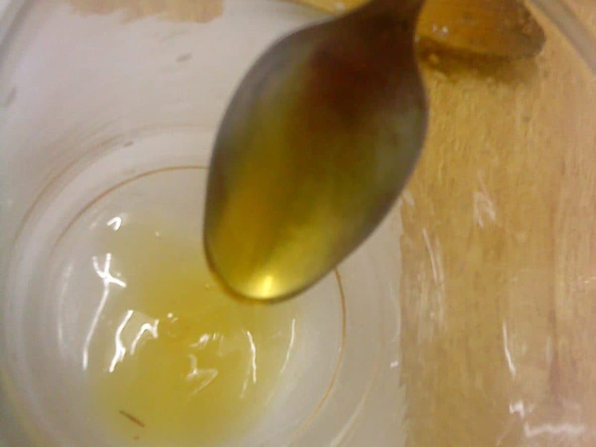 Golden syrup being spooned from a jar