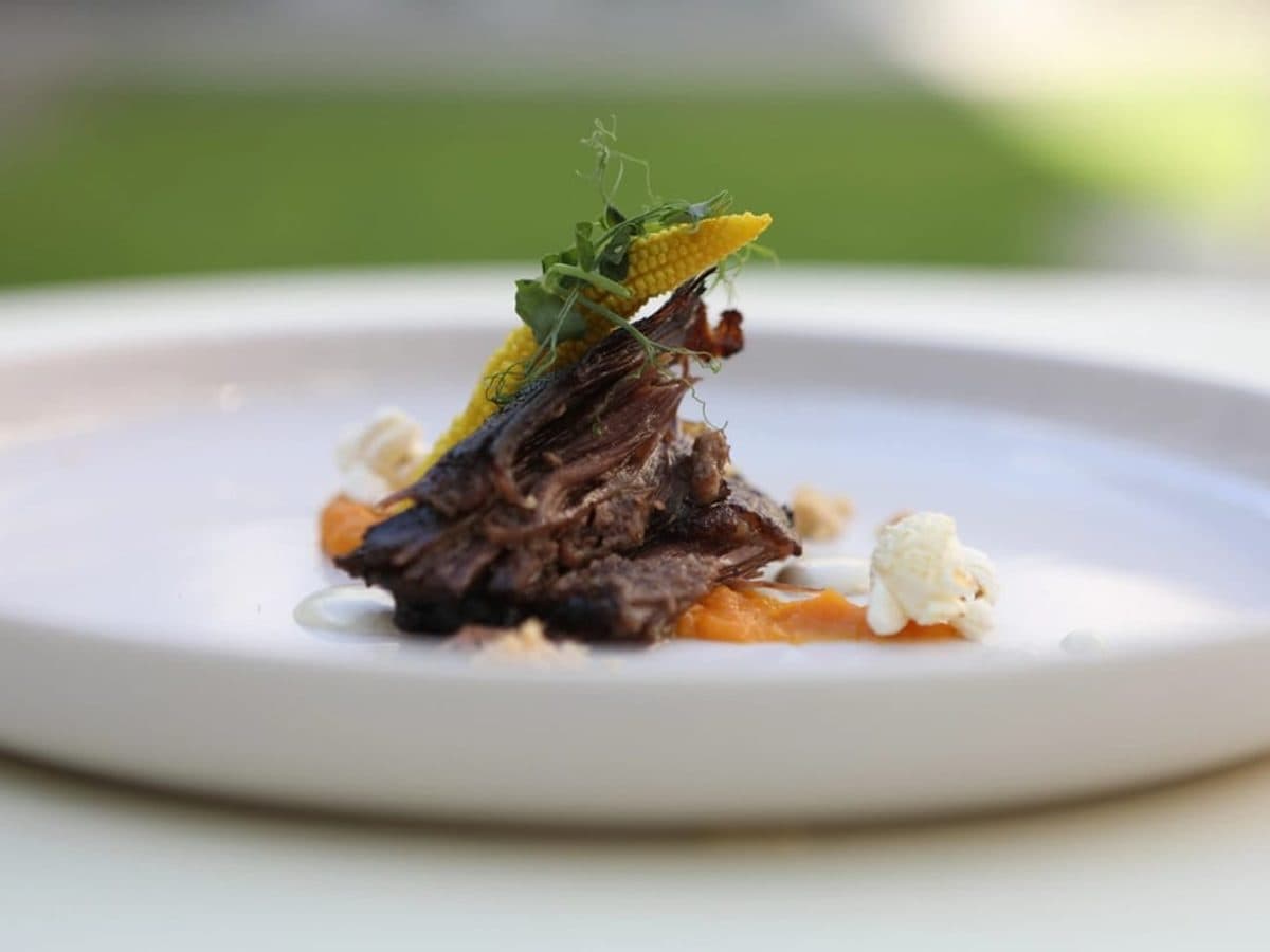 Raw beef short ribs on a dark surface