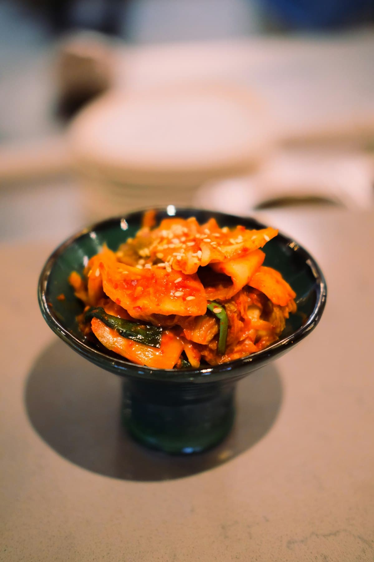 Stuffed cucumber kimchi pieces coated in red chili paste