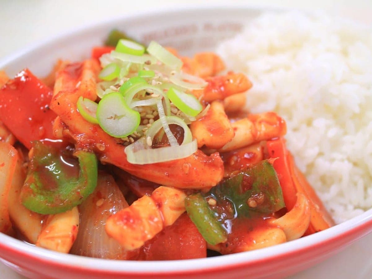Spicy stir-fried squid and vegetables served over white rice
