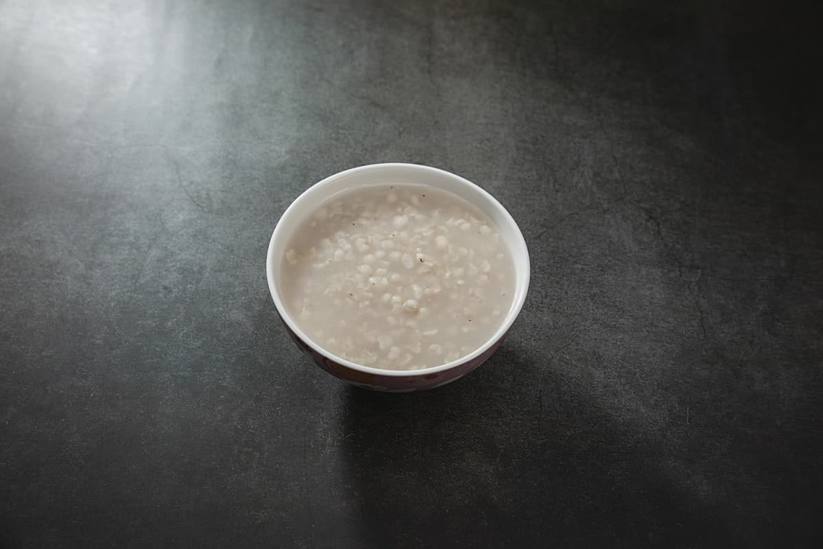 Pale sweet rice punch with floating grains in a bowl
