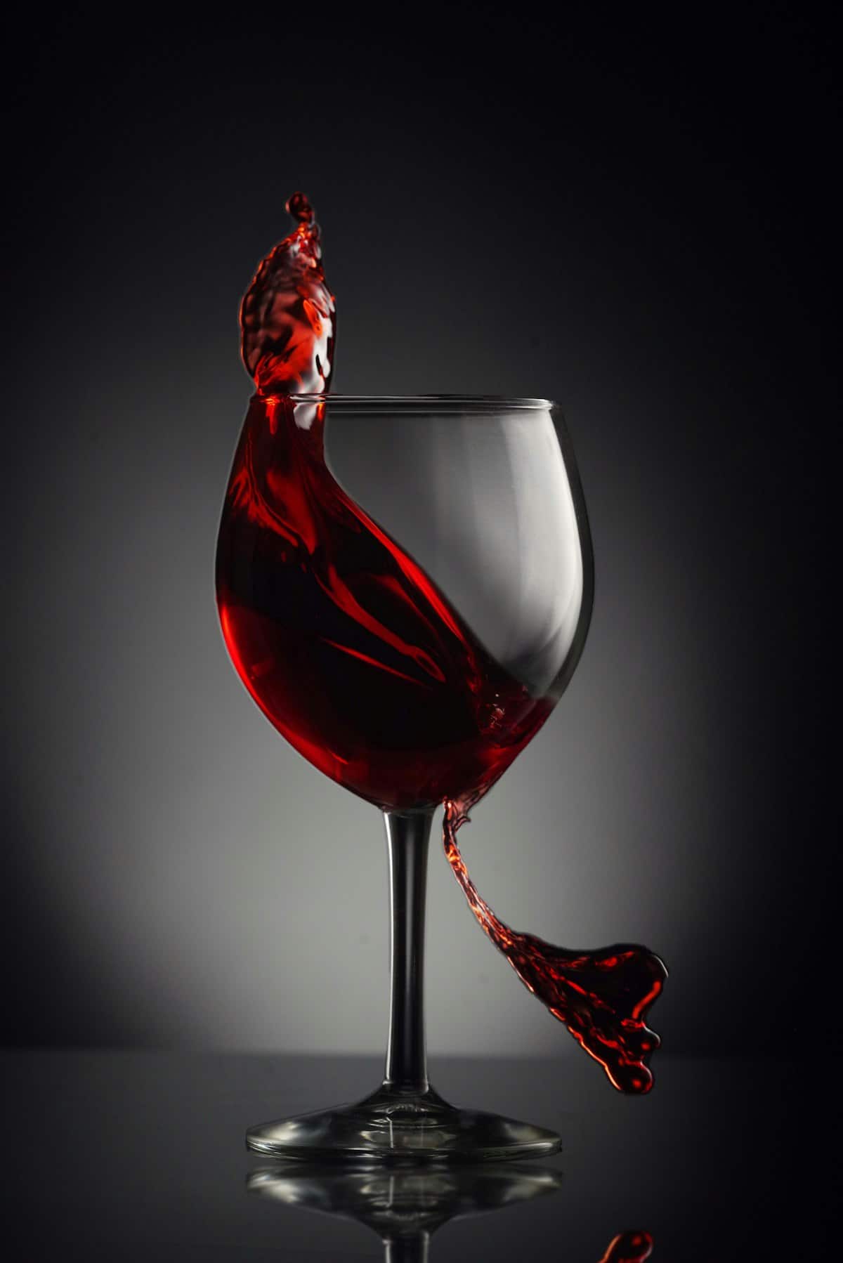 A glass of deep red-purple black raspberry wine