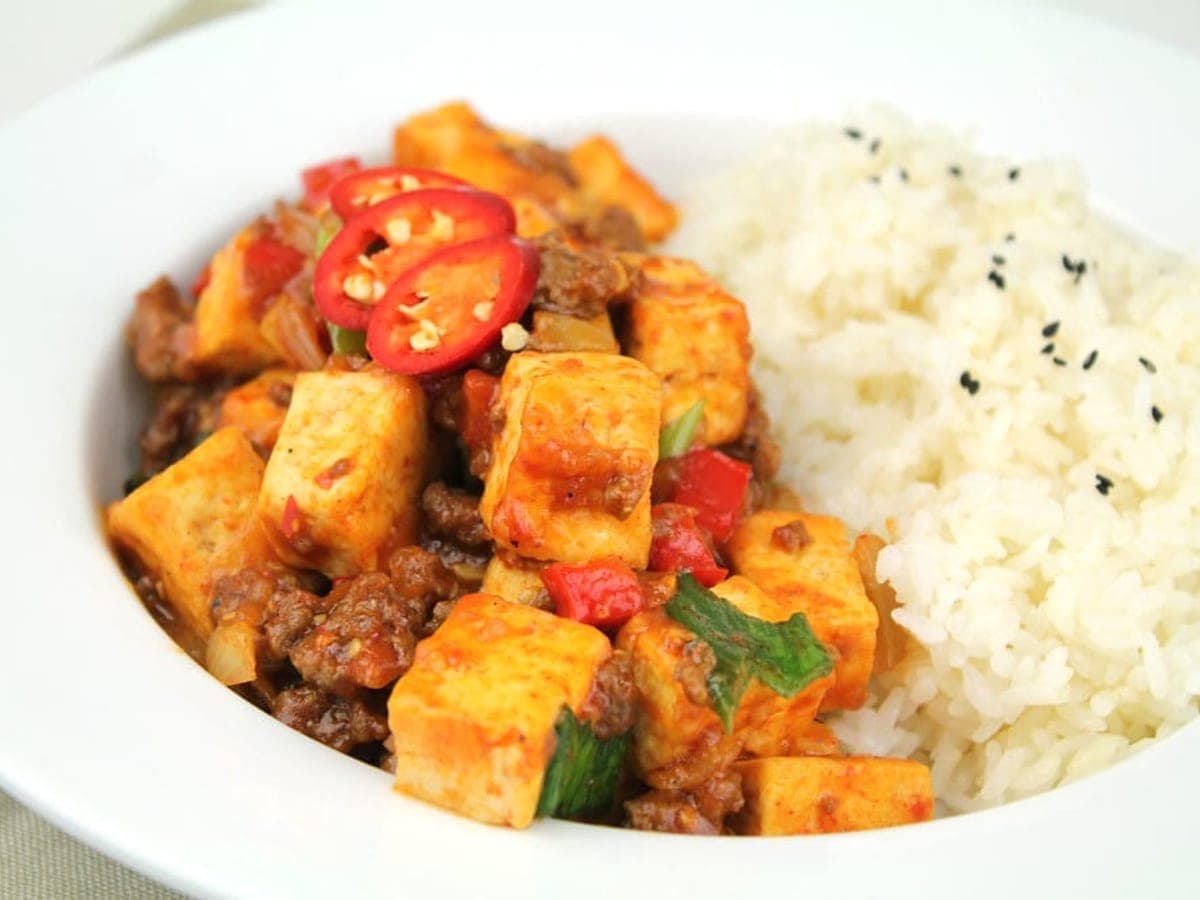 Pan-fried tofu slices braised in a red soy and chili sauce