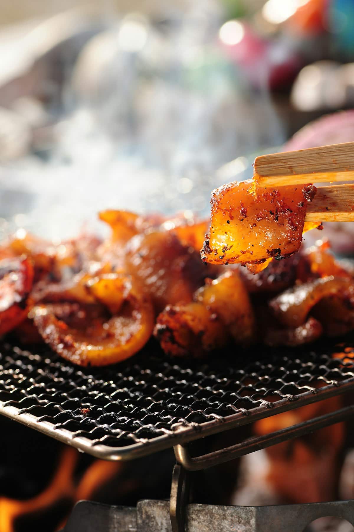 Grilled beef intestines with a crisp, charred exterior on a tabletop grill