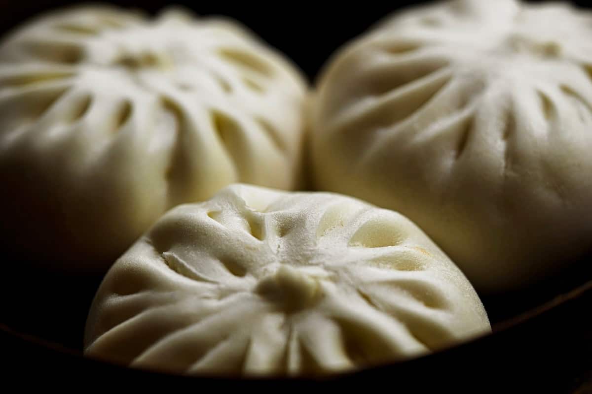 Pleated white steamed buns stacked together