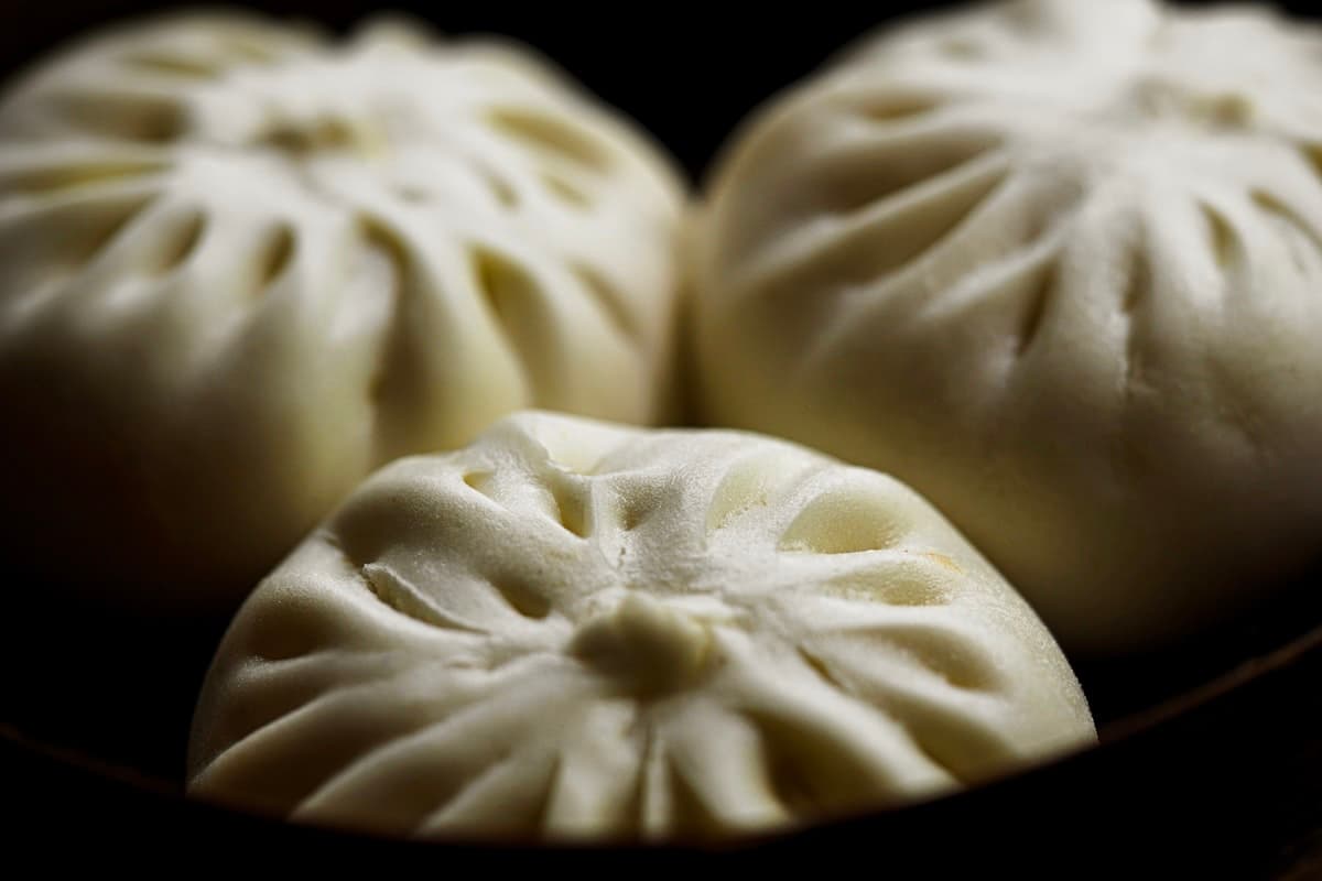 Pleated white steamed buns stacked together