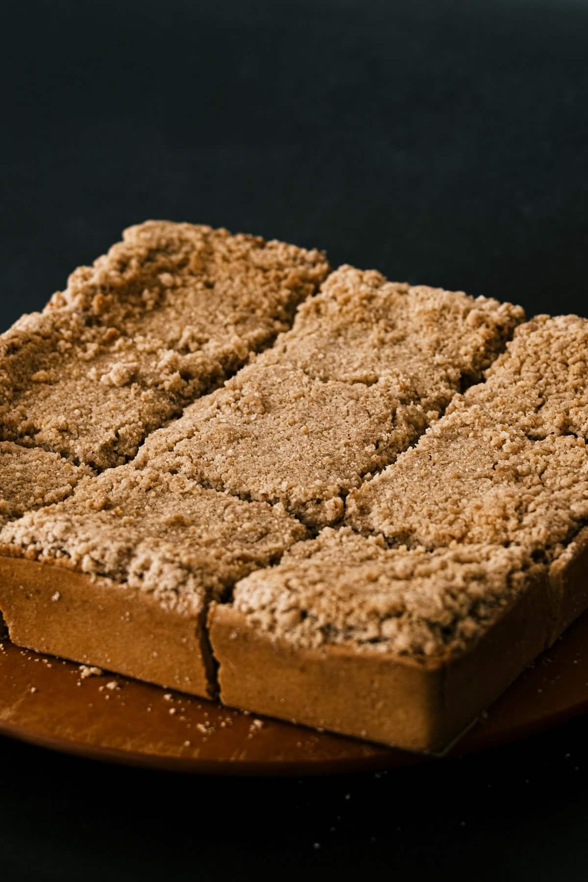 A block of rice cake coated in roasted soybean powder, sliced into pieces