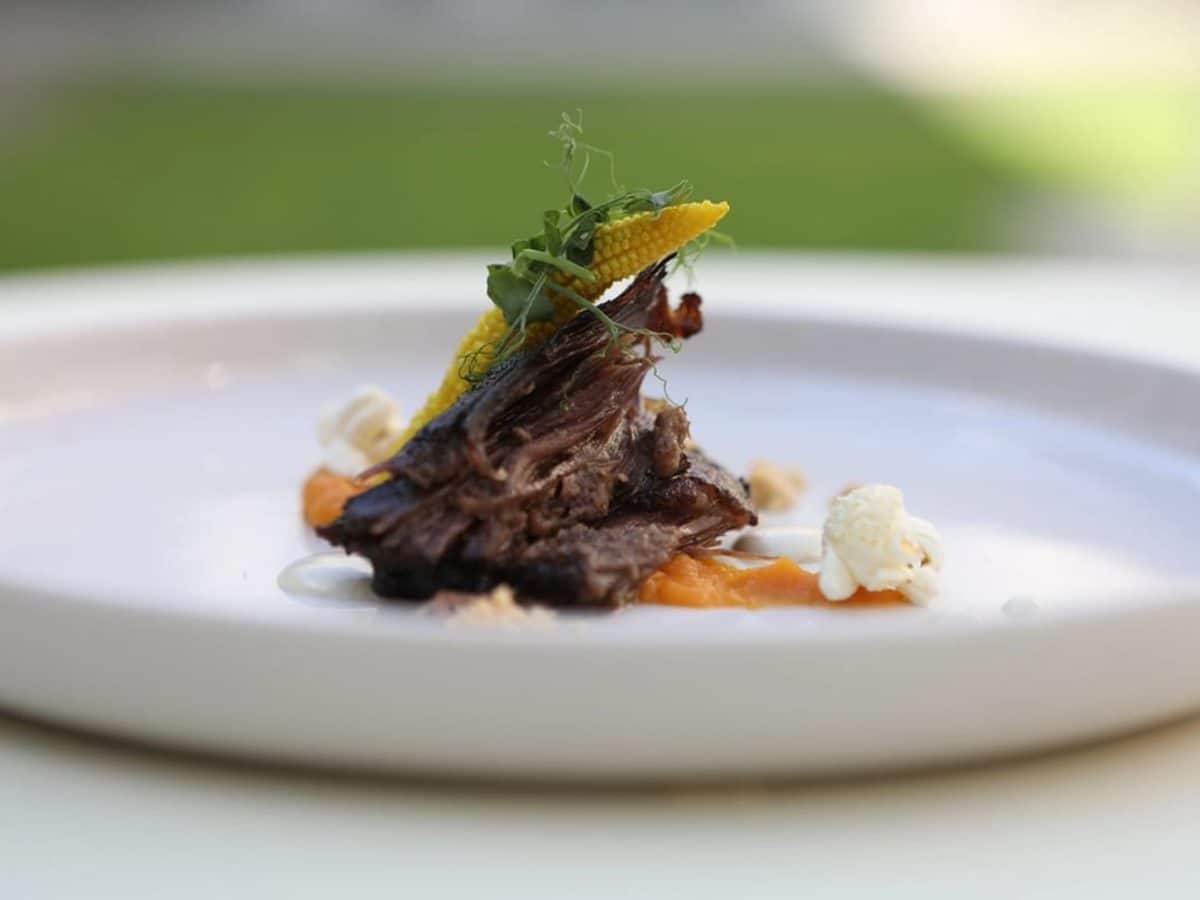 Raw beef short ribs on a dark surface