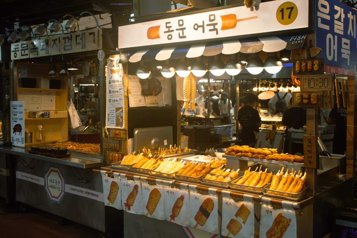 Fish cake skewers simmering in broth at a Korean street stall