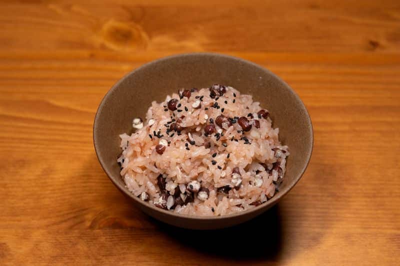 A bowl of multigrain rice with visible beans and black sesame seeds