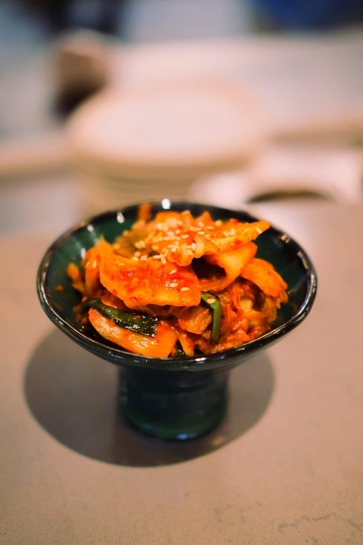 Stuffed cucumber kimchi pieces coated in red chili paste
