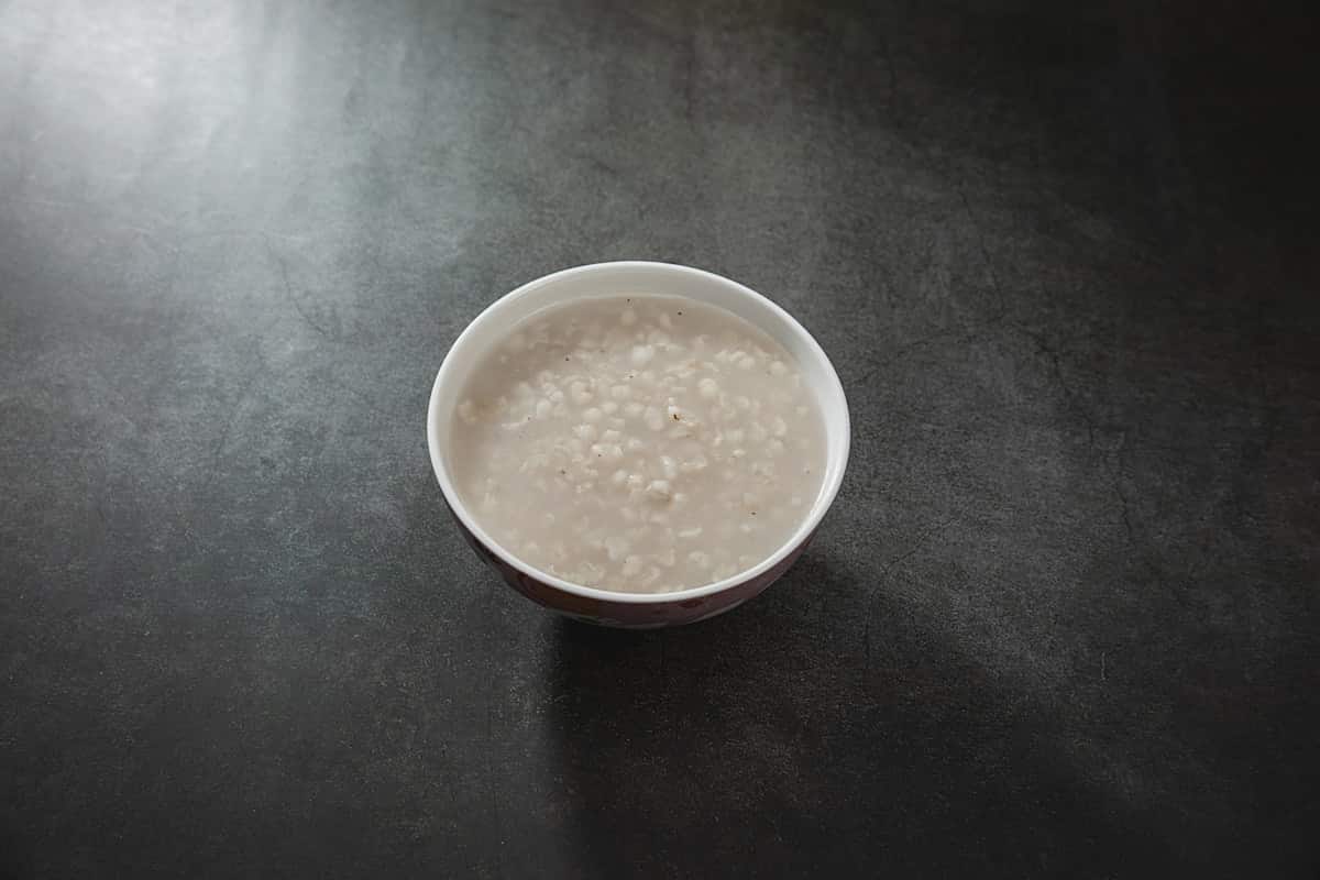 Pale sweet rice punch with floating grains in a bowl