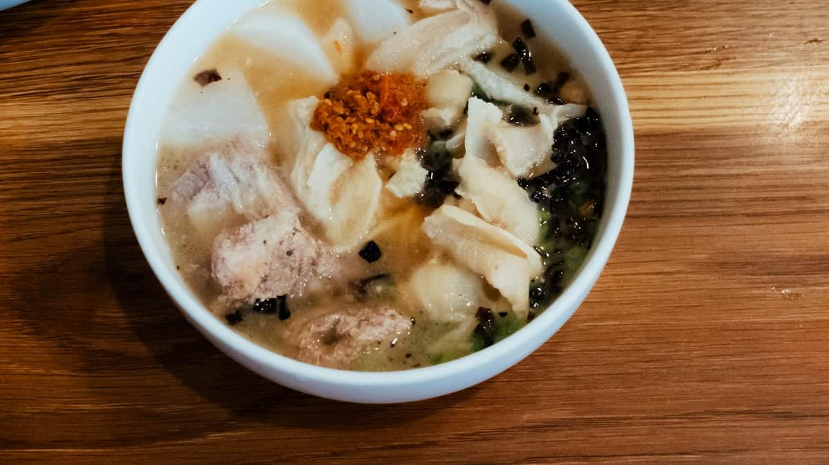 A bowl of sundae-guk with sliced blood sausage, offal, and gochujang