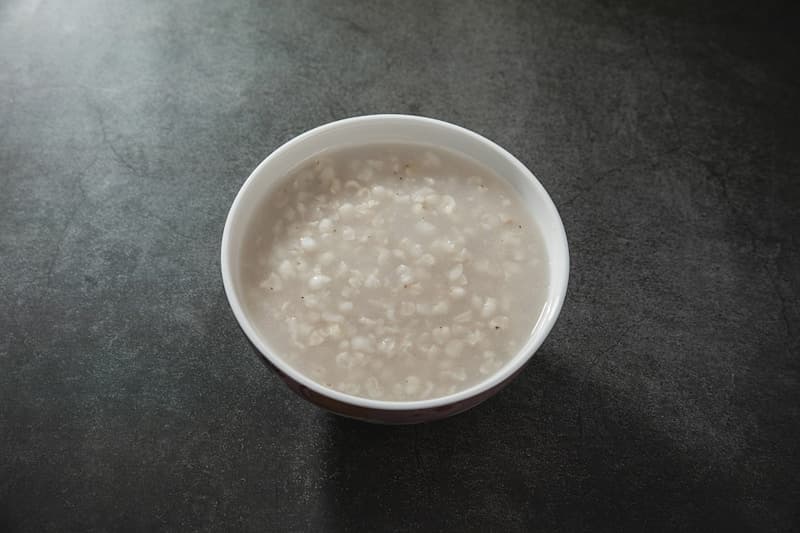 A bowl of pale toasted rice water with soft rice grains
