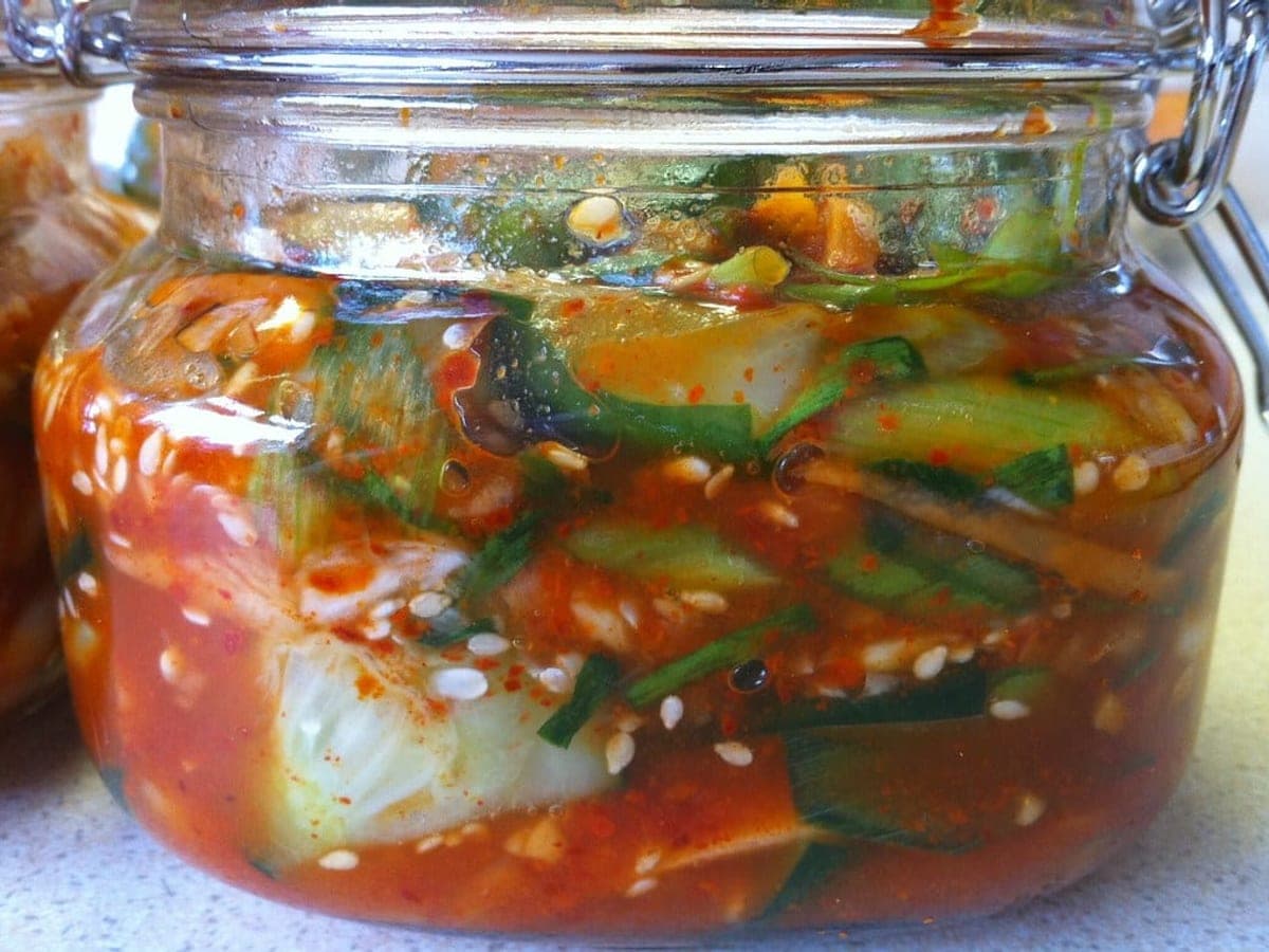 Kimchi fermenting in a glass jar